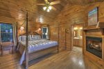 Master Bedroom on the Main Floor with a King Bed Flat Screen TV and Gas Log Fireplace